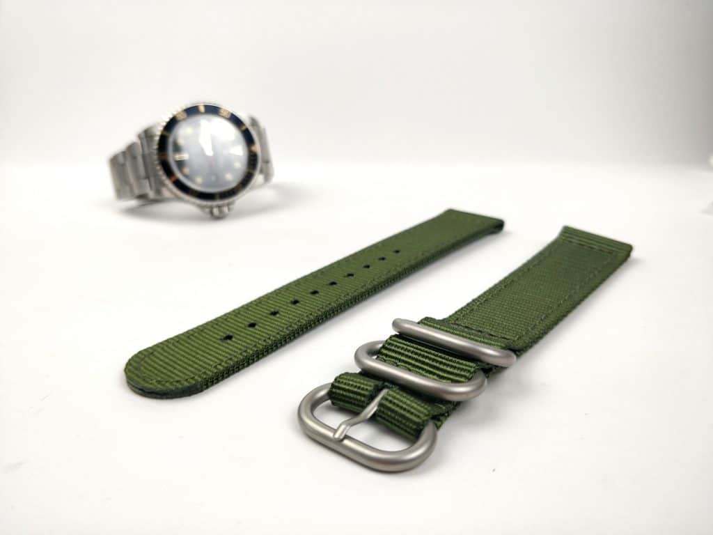 Close up of watch nato straps with a diving watch in the background